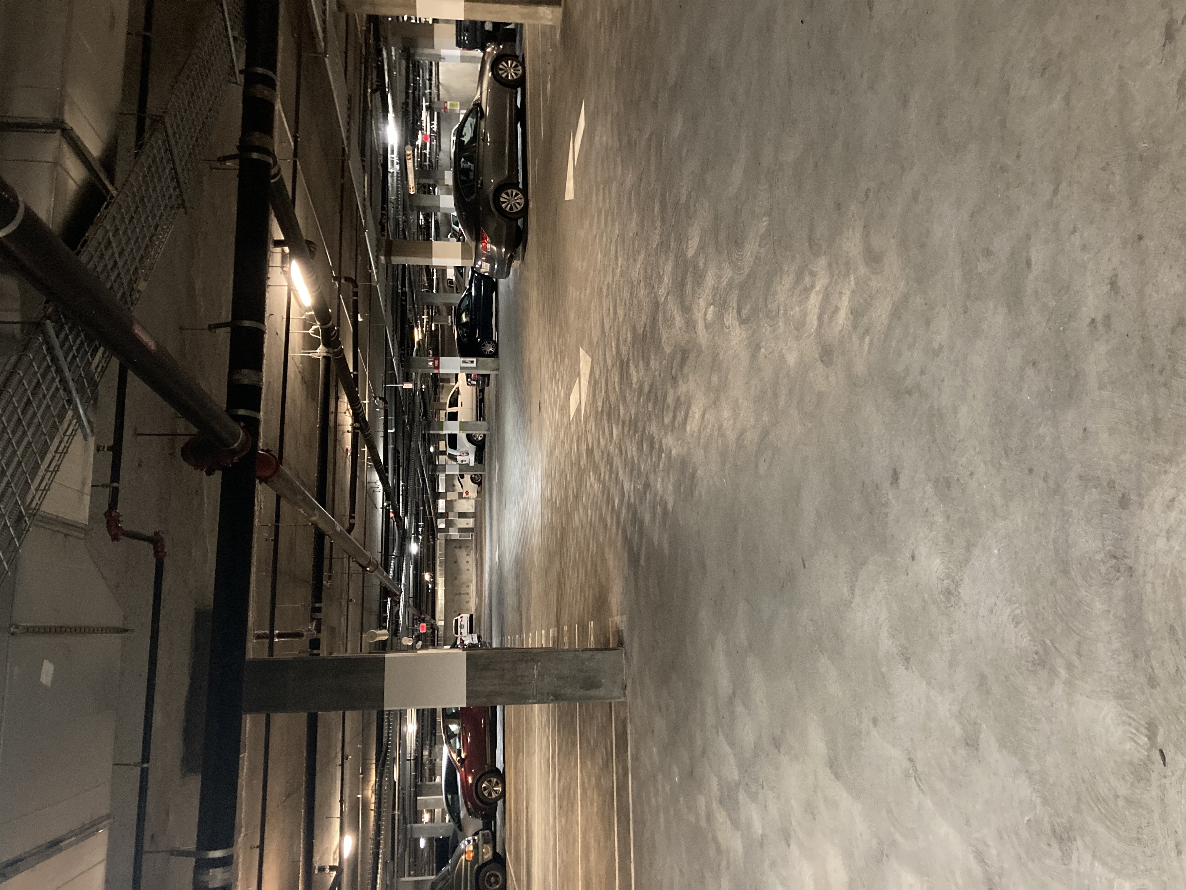 A long hallway with cars on the ceiling.