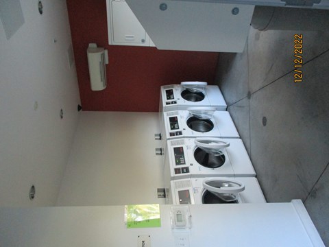 A row of washing machines in a laundromat.