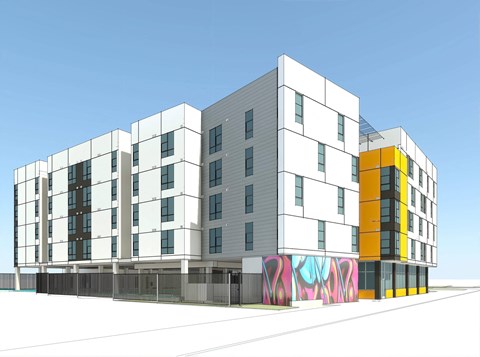 A modern building with a white facade and a yellow section on the right side.
