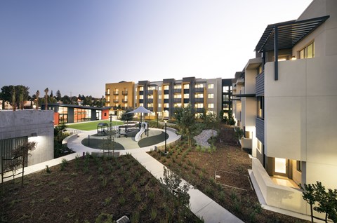 A modern building complex with a courtyard and trees.