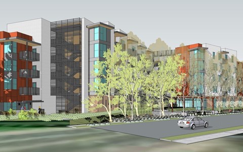 A car is parked on the side of a road in front of a row of buildings.