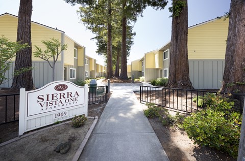 A Sierra Vista One Apartments sign is in front of a building.