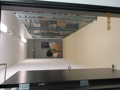 A room with a white floor and a black table with a metal frame.
