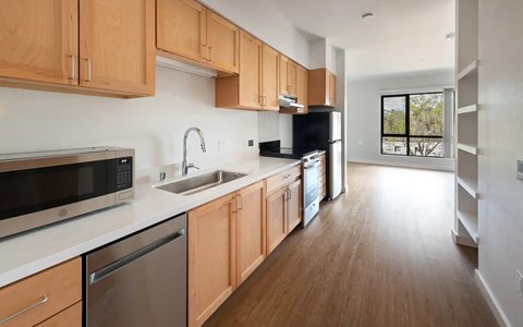 A kitchen with wooden cabinets and stainless steel appliances.