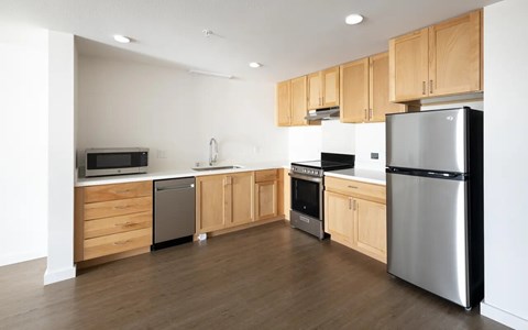 A kitchen with wooden cabinets and stainless steel appliances.
