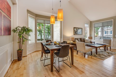 A dining room with a table set for six.
