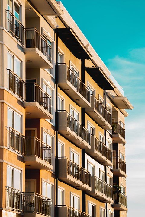 A tall building with balconies and windows.
