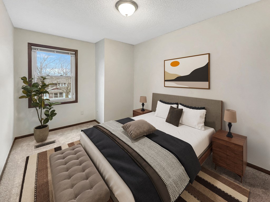 a bedroom with a bed and a window