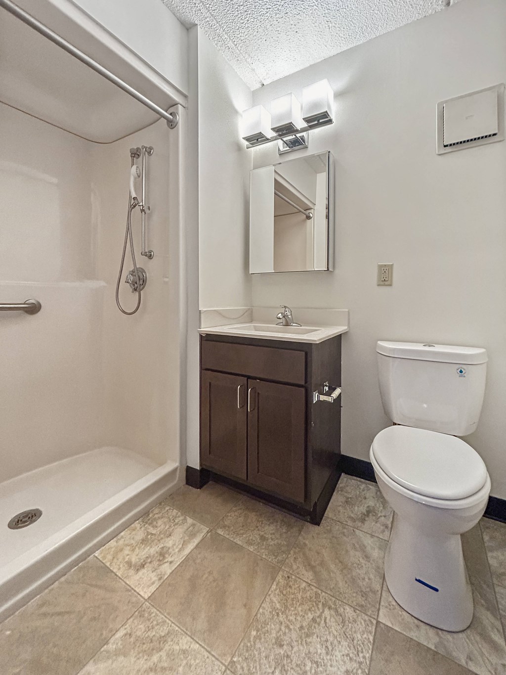 a bathroom with a toilet sink and shower