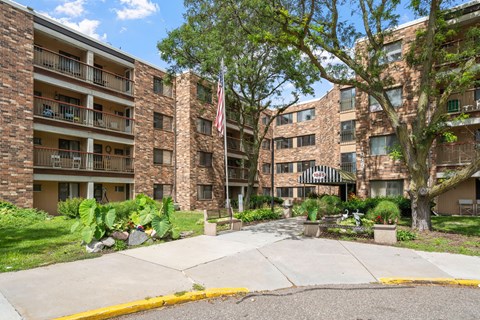 an apartment building with an flag in the courtyard