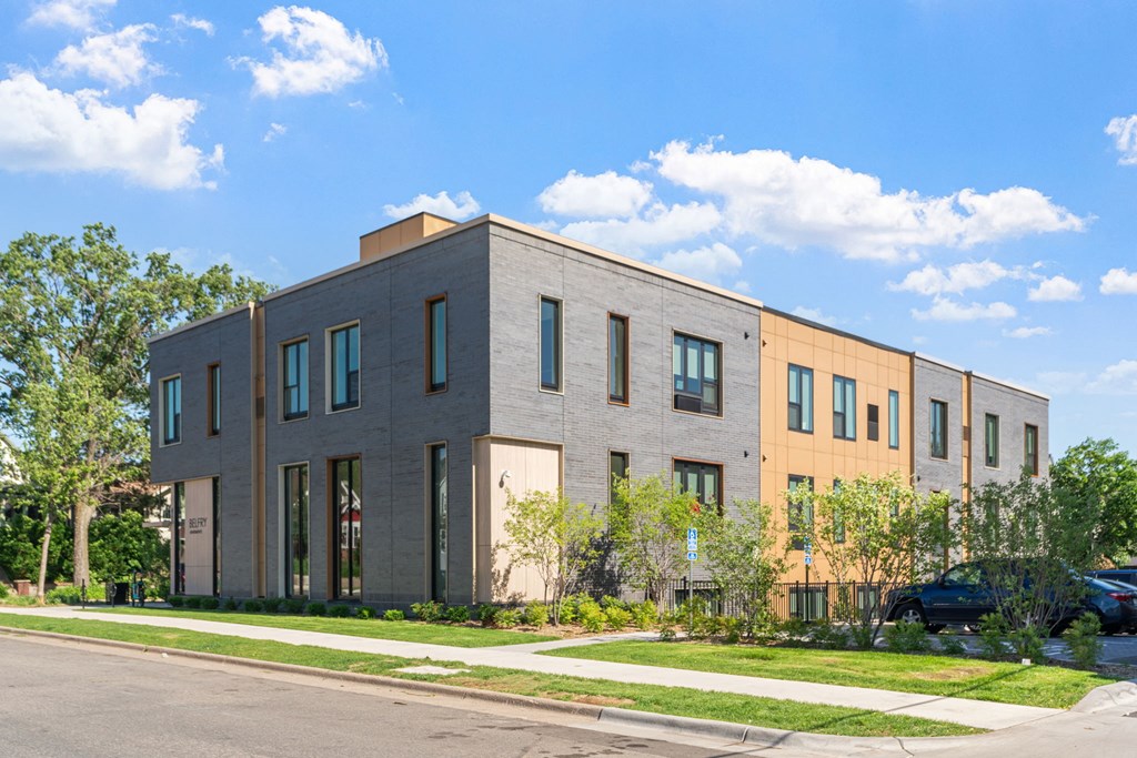 a three story building with a street in front of it