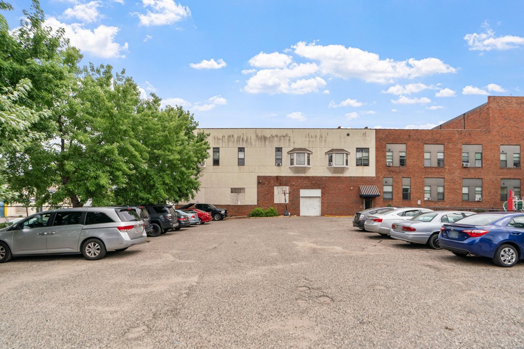 a large brick building with cars parked in front of it