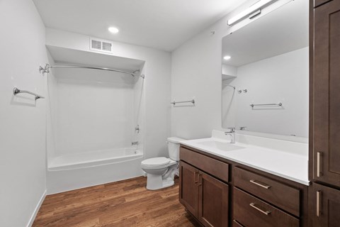 a bathroom with a toilet sink and shower and a mirror