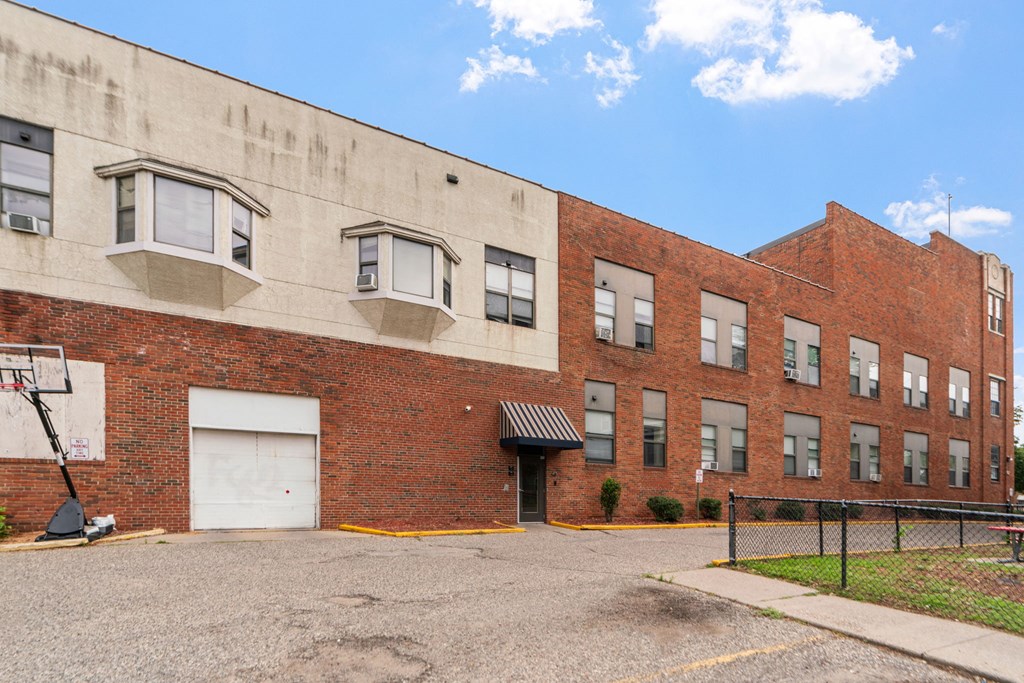 the back of a brick building with a white garage door