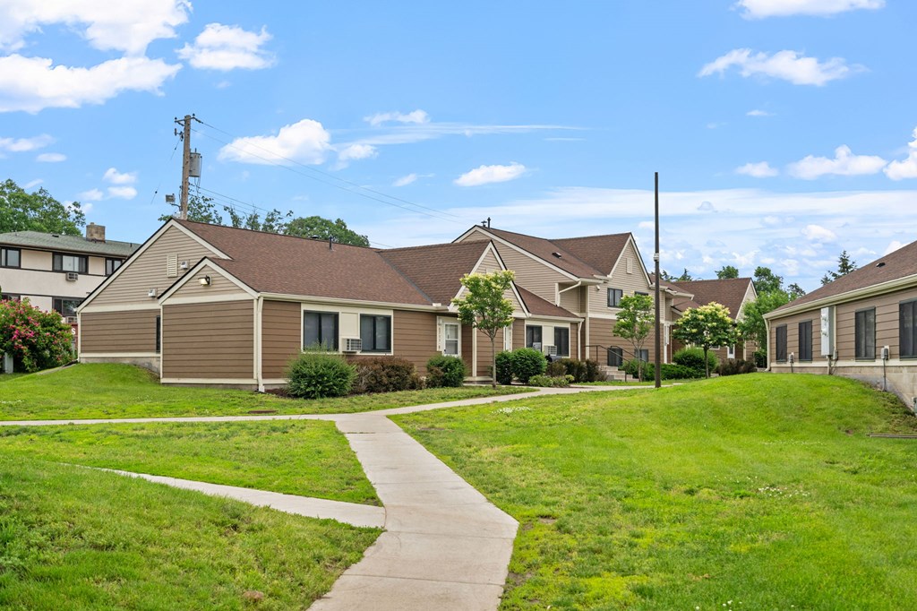 a row of houses in a neighborhood with a sidewalk