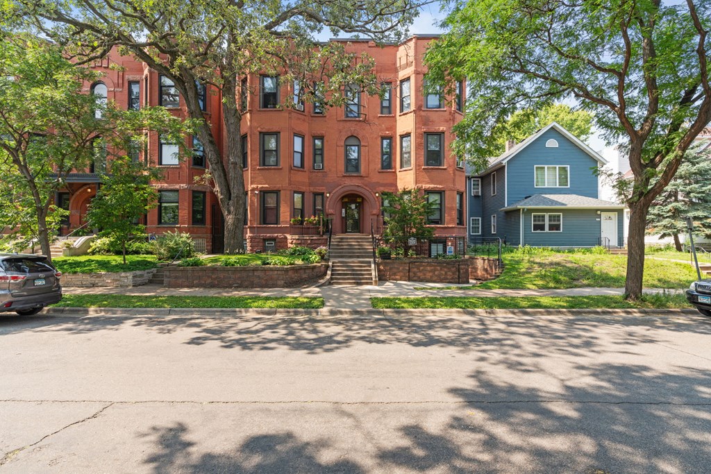 a red brick building with trees in front of it