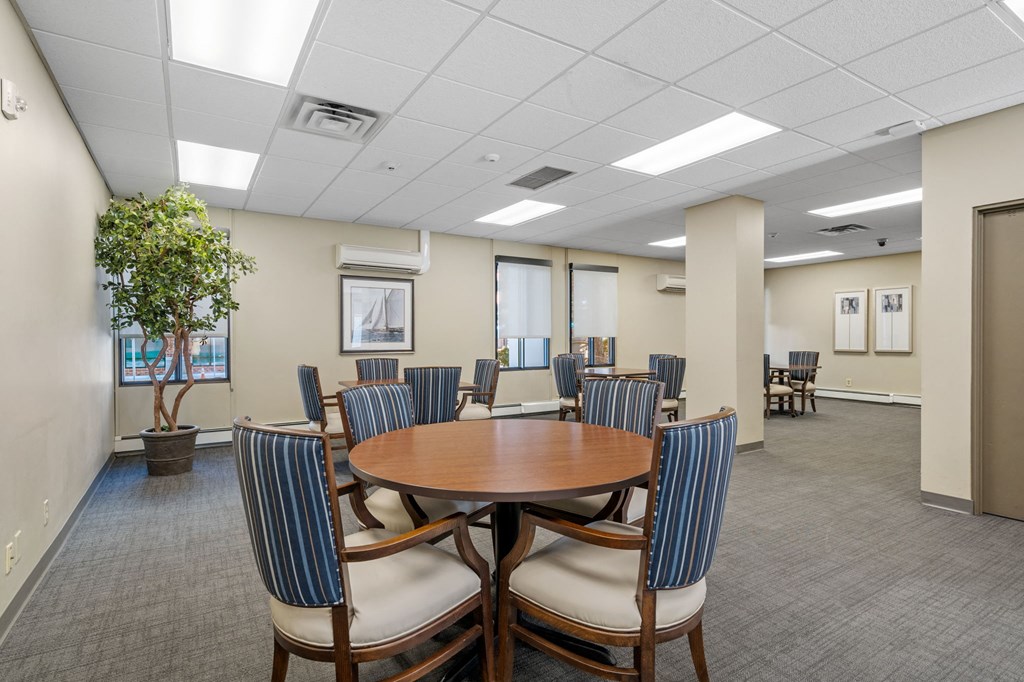 a conference room with a round table and chairs