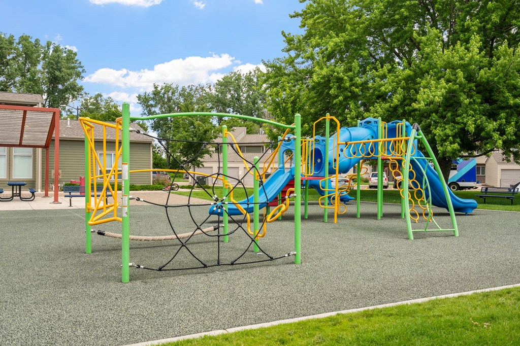 a playground with a swing set in a park