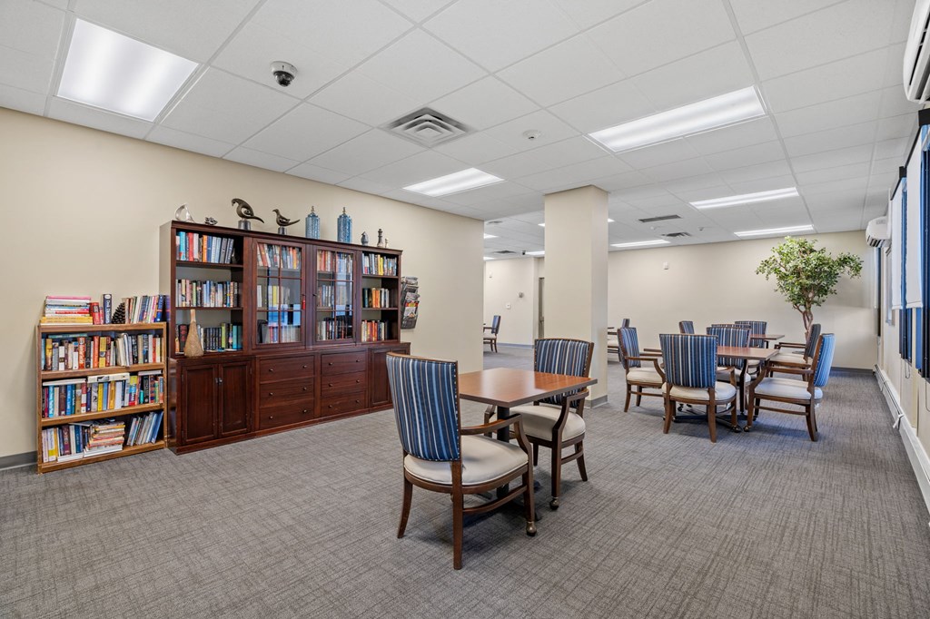 a dining room with tables and chairs and a library