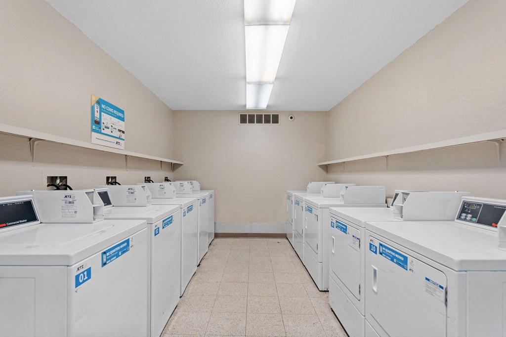 a washer and dryer hall with white washers and dryers on the
