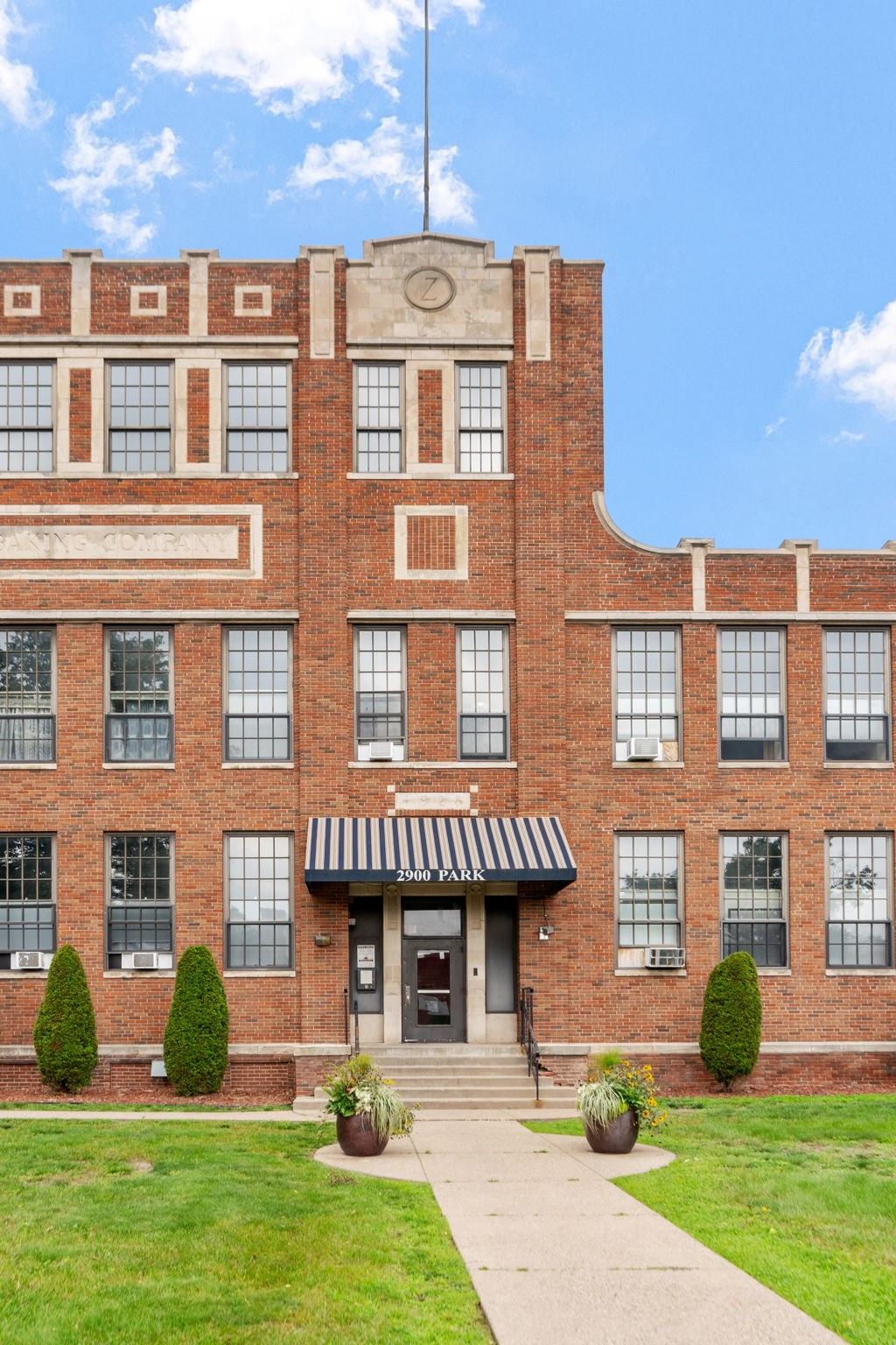 a large brick building with a flag on top of it