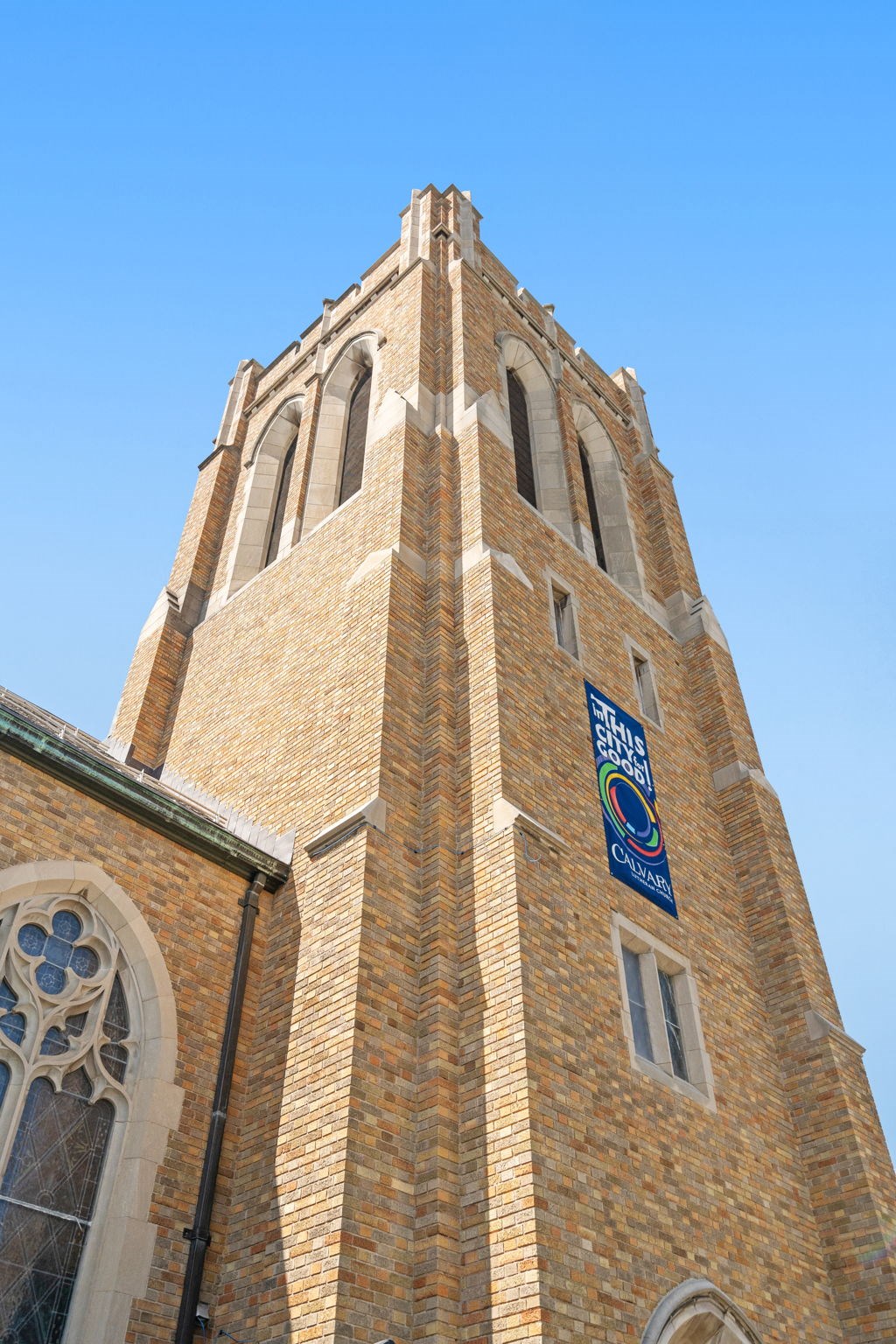 the top of a church tower with a sign on it