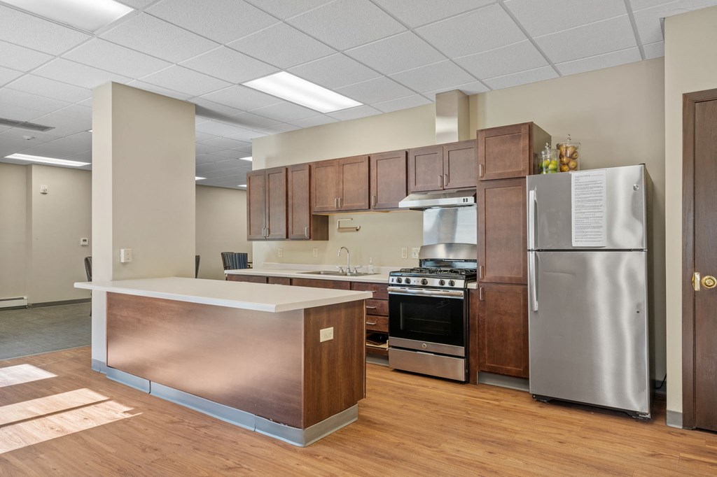 a kitchen with stainless steel appliances and wooden cabinets
