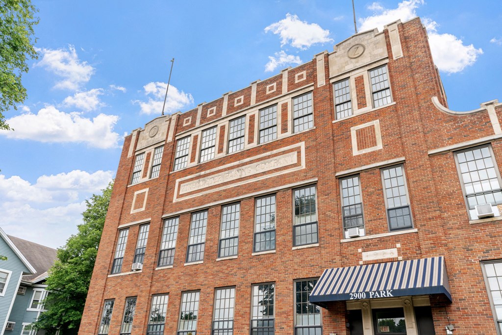 a red brick building with a black and white awning