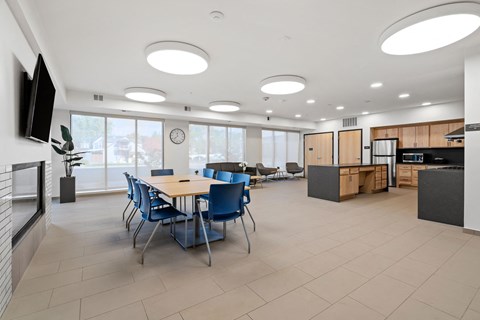 a dining room with a table and chairs and a kitchen