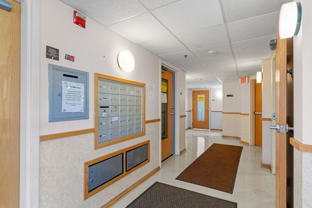 a hallway in a hospital with doors and walls and rugs