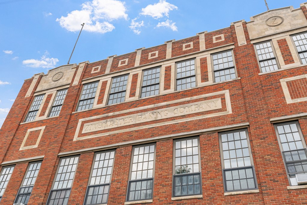 a red brick building with a sign on the side of it