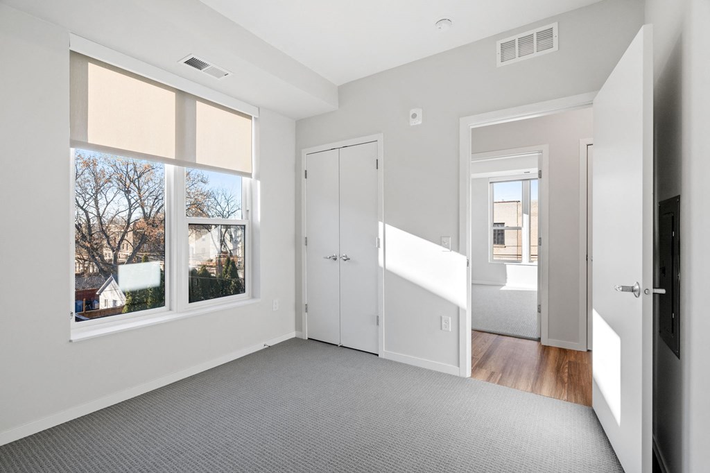 a living room with a large window and a door