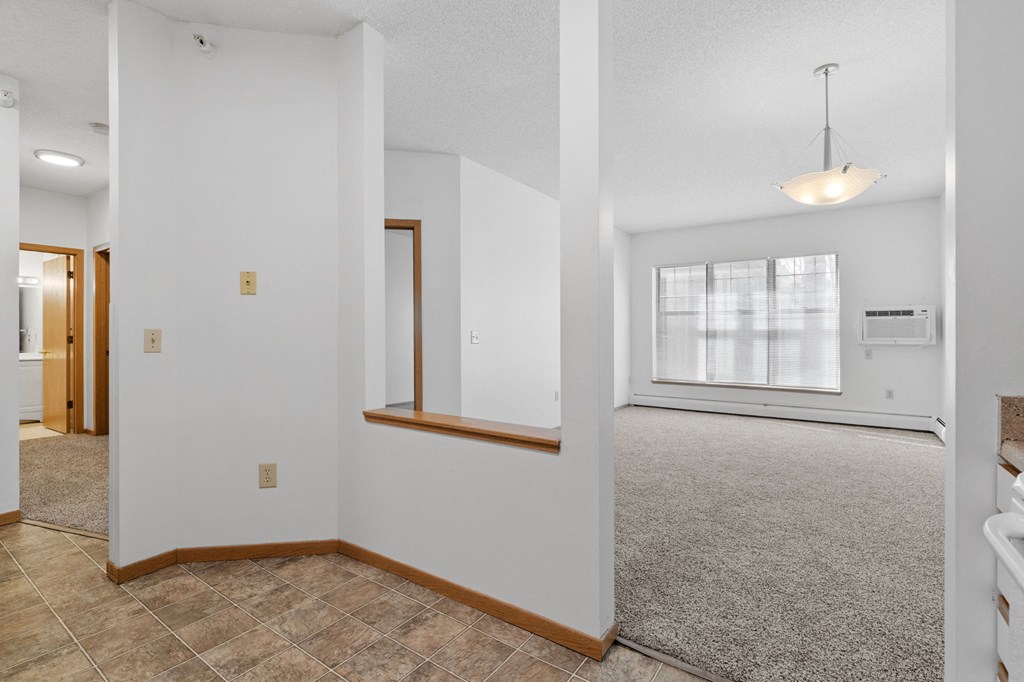 an empty room with a reflection of lights on the floor