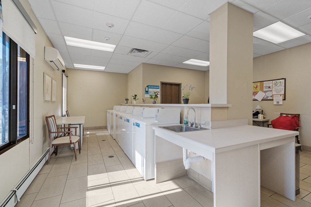 a room with white tables and chairs in it