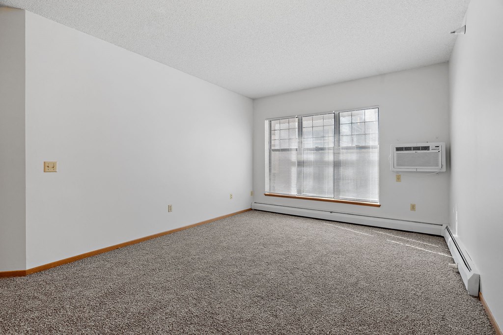 Photo of living room with large windows and wall mounted air conditioner