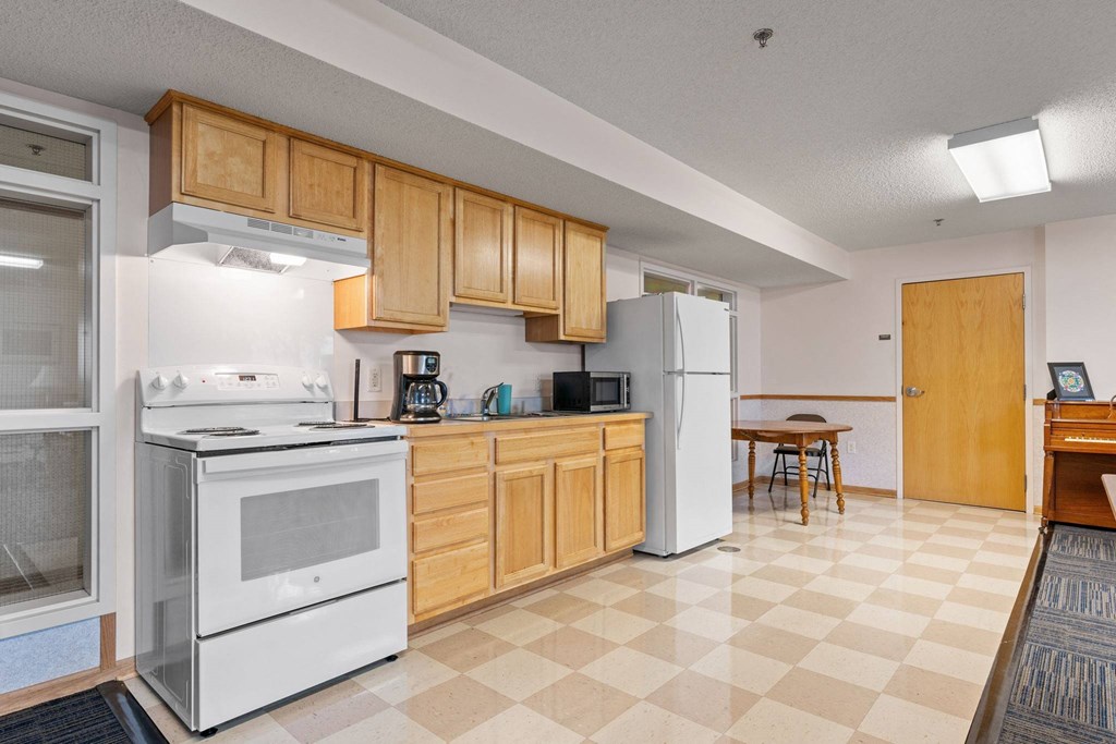 a kitchen with white appliances and wooden cabinets