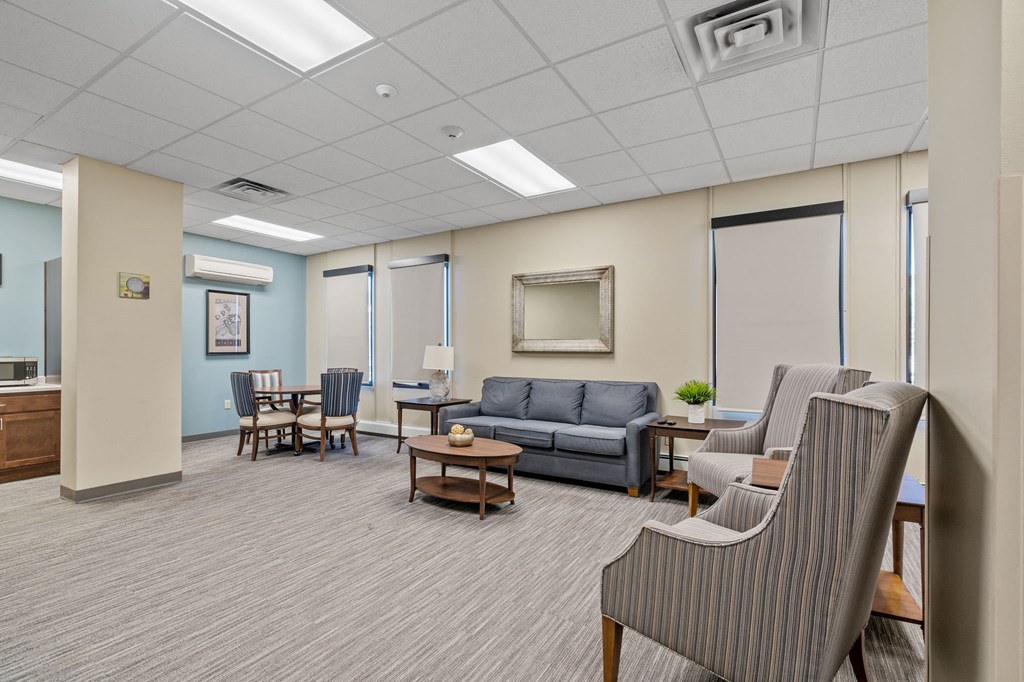 a living room with couches and chairs and a table