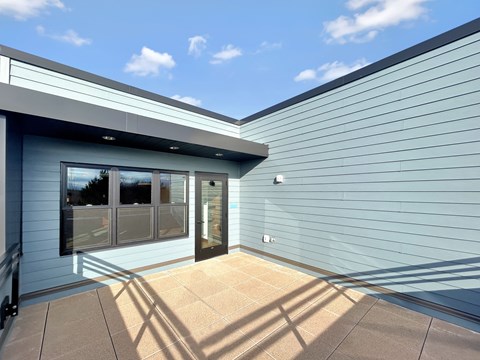 the front of a blue building with a glass door