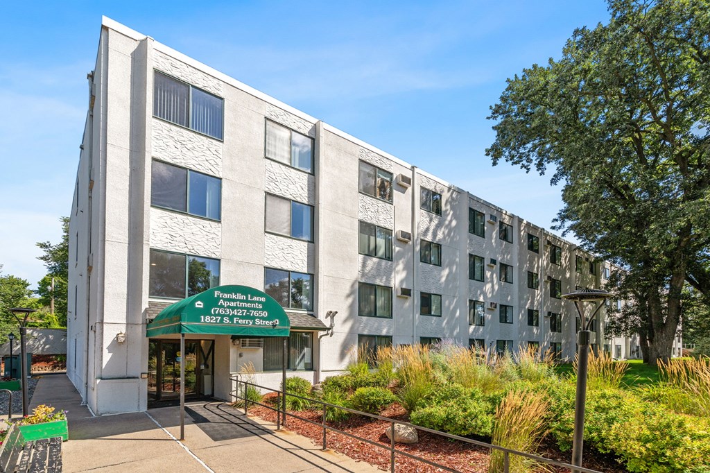 a large building with a green sign in front of it