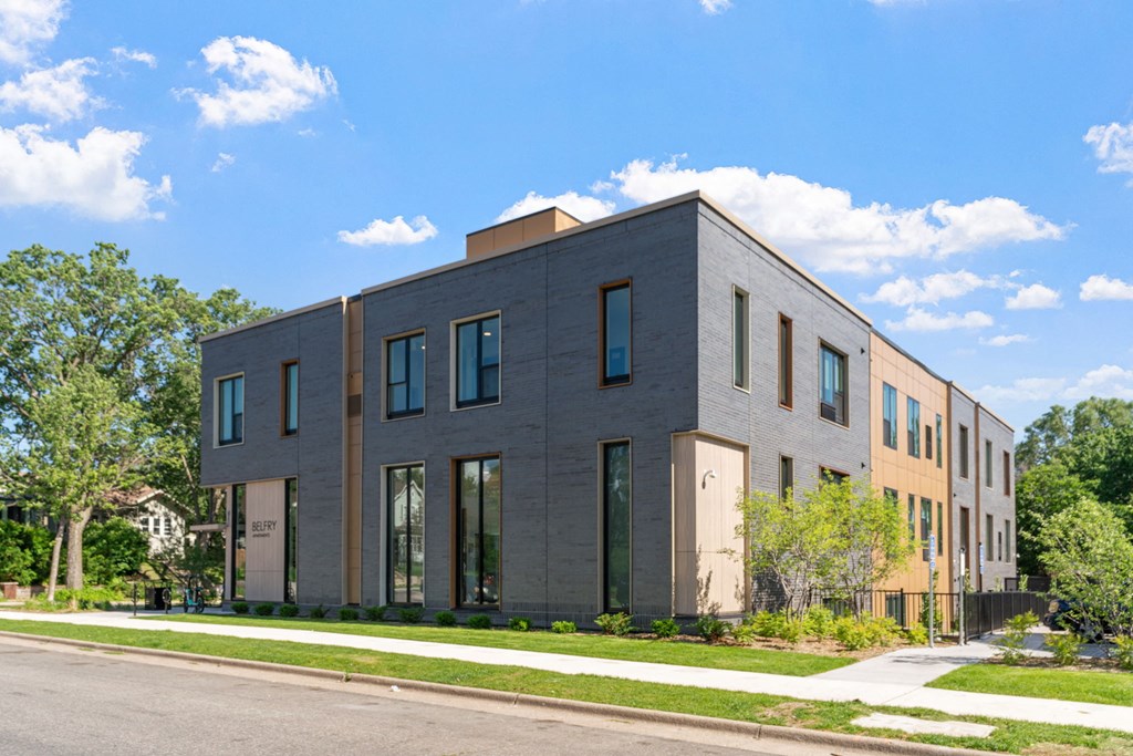 a three story building with a street in front of it