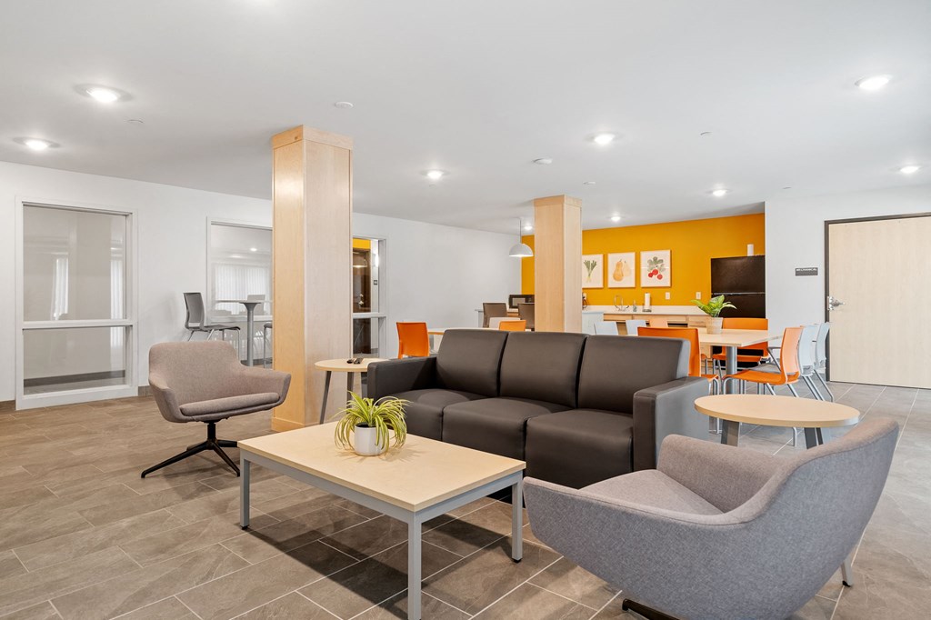 a living room and dining room with couches and chairs