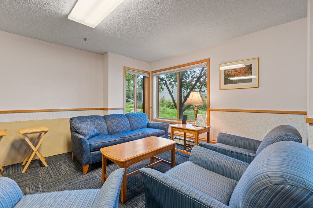 a living room with couches and chairs and a table