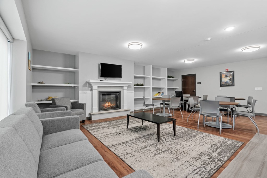 a living room with a staircase and a fireplace