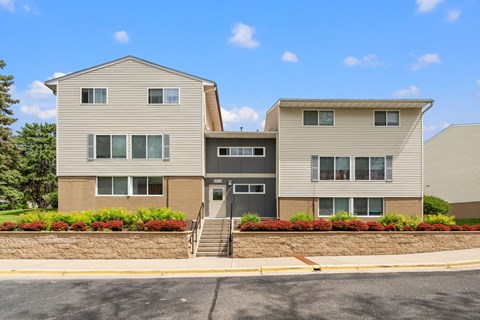 the view of an apartment building with a staircase in front of it