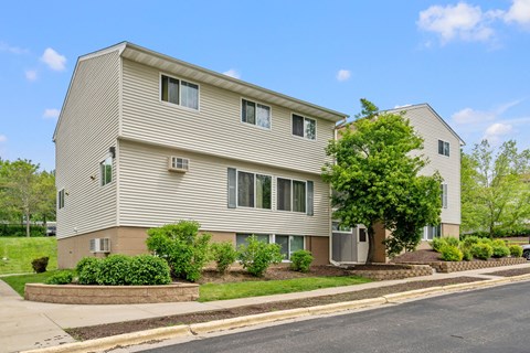 an apartment building with a street in front of it
