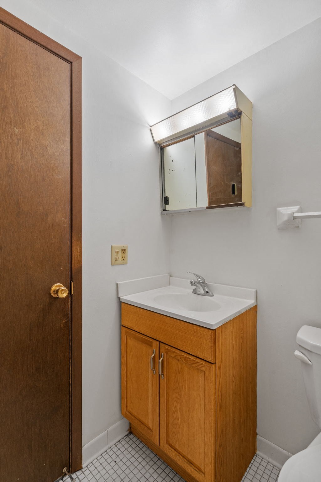 a small bathroom with a sink and a mirror