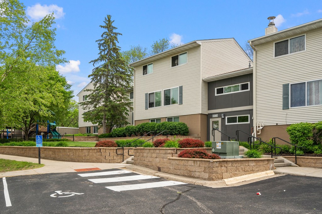 an apartment building with a pedestrian crossing in front of it