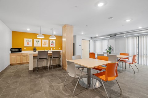 A modern dining area with a table surrounded by chairs.