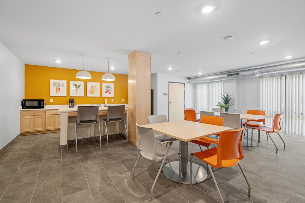 A modern dining area with a table surrounded by chairs.