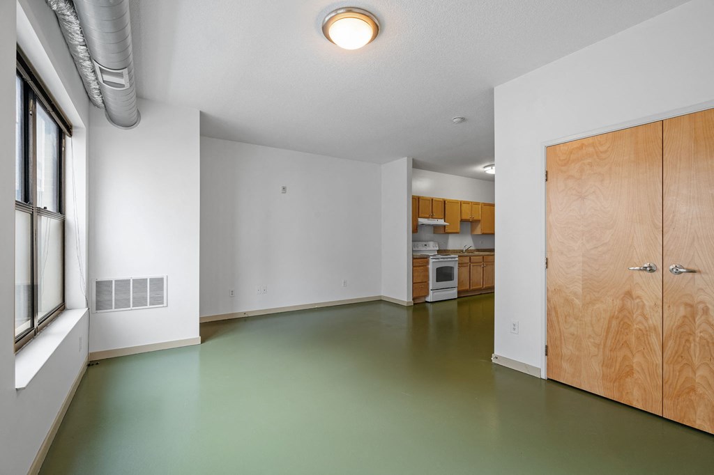 an empty room with white walls and a wooden door